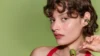 Bose Ultra Open Earbuds (2nd Gen) Olive Green – žena s olivově zeleným sluchátkem nasazeným na ušním boltci jako náušnice