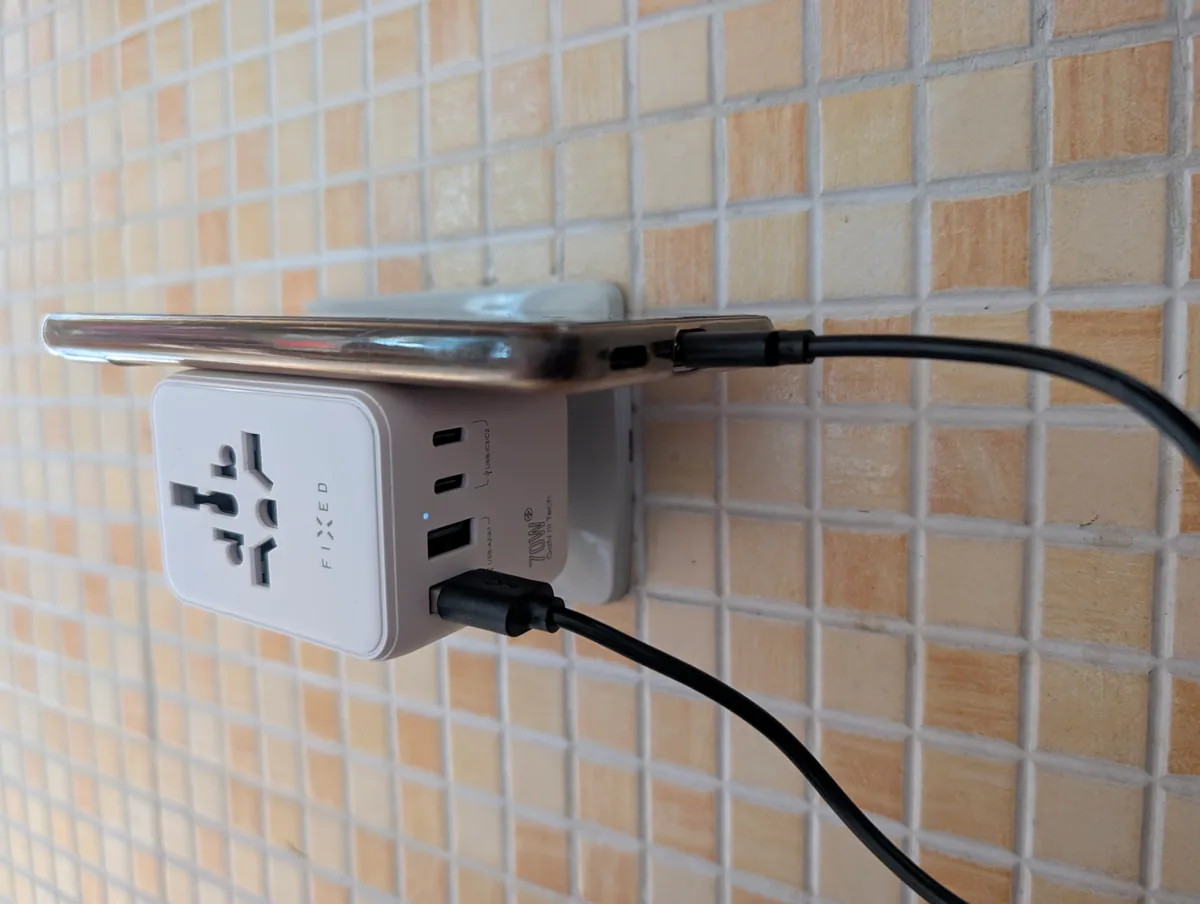 Cestovní adaptér FIXED Voyager 70W nabije z jedné zásuvky pět zařízení 1 Bok adaptéru FIXED Voyager 70W s porty USB-C a USB-A, svítící modrou kontrolkou a popiskem 70W GaN III Tech