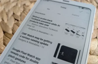 Kapesní čtečka Boox Palma 2 s e-ink displejem leží na pletené podložce a zobrazuje seznam článků